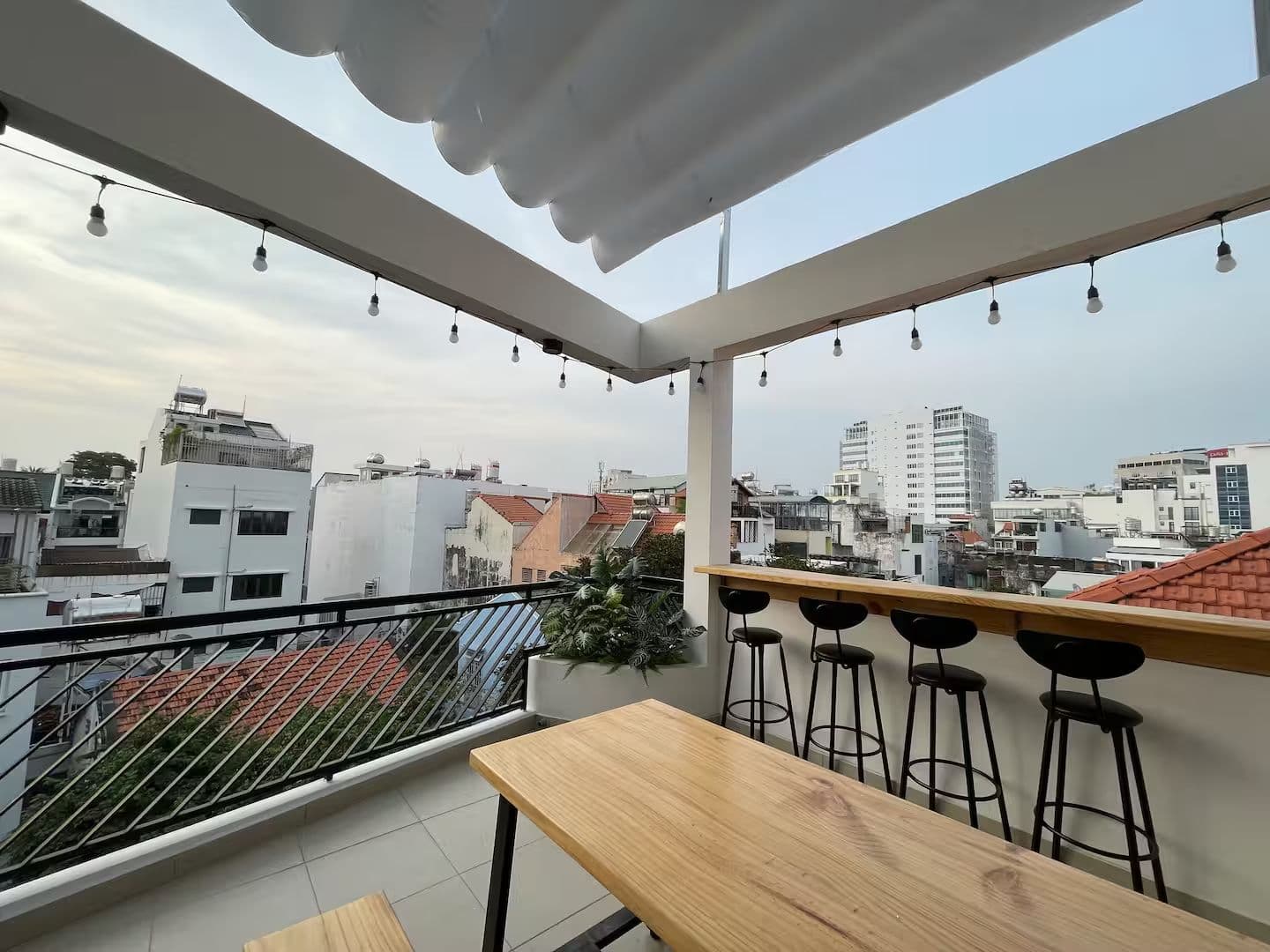 The rooftop terrace at Duhaus 48, over the tiled roofs of Phú Nhuận
